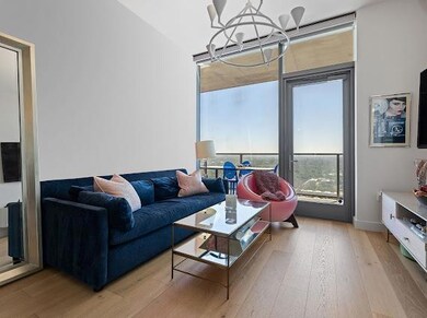 Living room without wallpaper with floor-to-ceiling windows and balcony to Lady Bird Lake