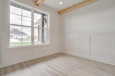 Unfurnished room with light hardwood / wood-style flooring and beam ceiling