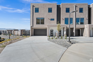 View of front facade with driveway and 2 car attached garage