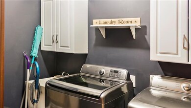 updated laundry room with newly installed cabinets