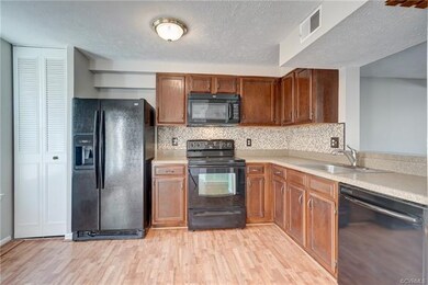Open kitchen with a backsplash and pantry