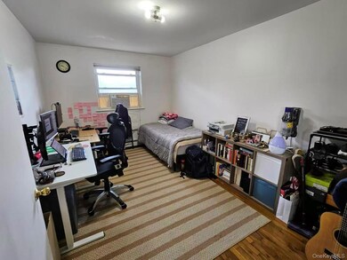 Bedroom featuring a desk, dark wood finished floors, and cooling unit