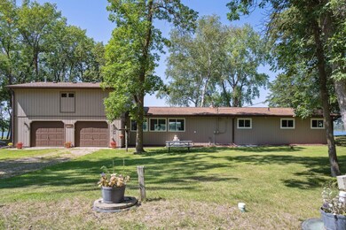 The garage has 4 garage door openings, 2 in the front & 2 in the back making it easy to get that boat to the lake.