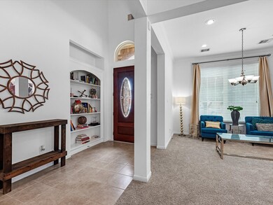 Grand foyer entry, custom built-ins, & a view of t