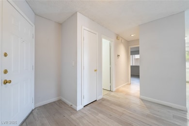 Foyer featuring light wood-type flooring, baseboar
