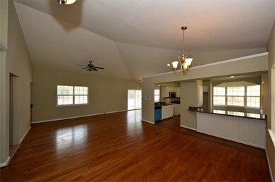 Huge open great room with wet bar, kitchen and dining under the cathedral ceiling.