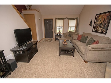 The large great room has a vaulted ceiling and new