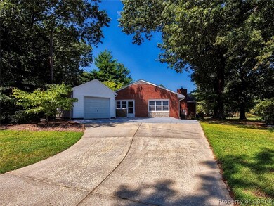 paved drive way leading to garage and house.