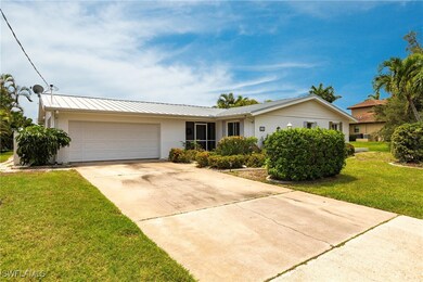 Single story home with a garage and a front lawn