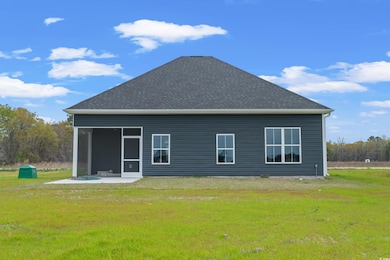 Back of property featuring a yard