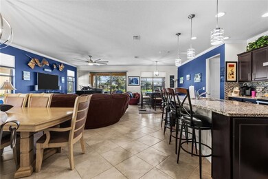 Dining area with crown molding, a ceiling fan, light tile patterned floors, a textured ceiling, and recessed lighting