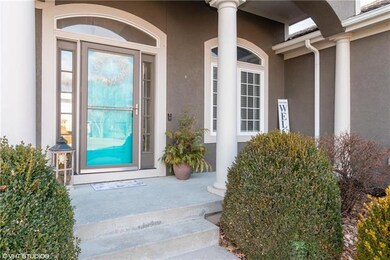 Guests arrive on a covered front porch with a stor
