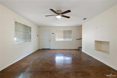 Unfurnished living room with concrete flooring, ceiling fan, and plenty of natural light