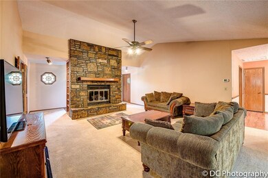 Built-in cabinetry on both sides of the fireplace; entry behind native stone fireplace