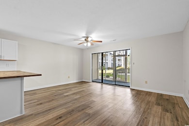 Unfurnished living room with ceiling fan, baseboar