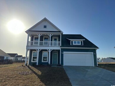 View of front of home with driveway, roof with shi