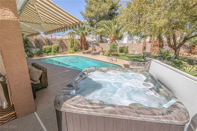 View of swimming pool with a fenced backyard, a fe