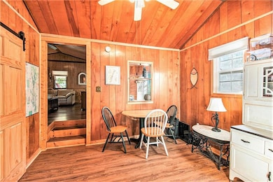 Dining room with wooden ceiling, wood finished flo