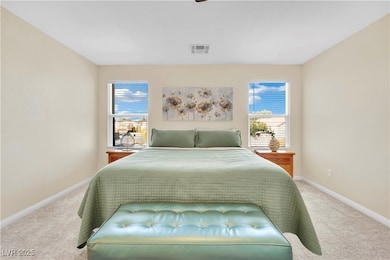 Bedroom featuring light colored carpet and ceiling fan