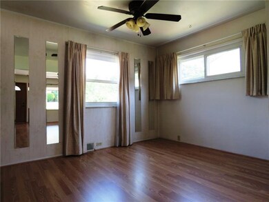 Dining room with updated flooring and ceiling fan.