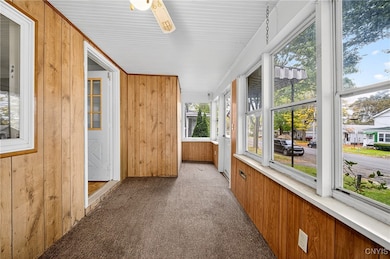 Front enclosed porch, leads into the kitchen.