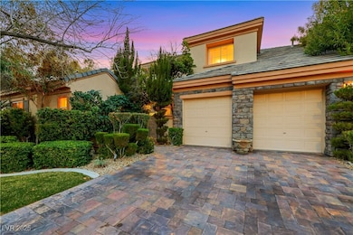 View of front of house featuring a garage, stone s