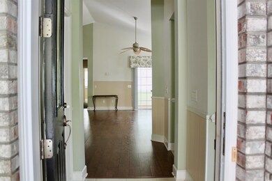 Hallway with dark hardwood / wood-style flooring a
