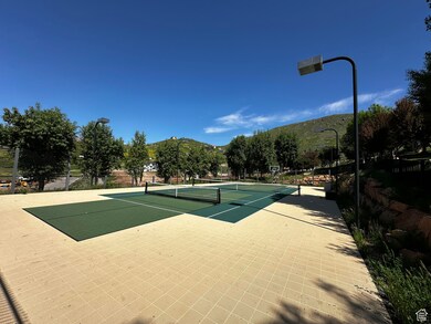 View of sport court with a mountain view and fence