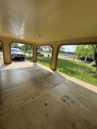 Garage featuring a carport