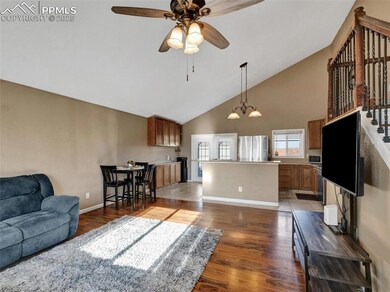 Living room with ceiling fan with notable chandeli