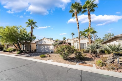Mediterranean / spanish house with stucco siding, an attached garage, driveway, and a tile roof