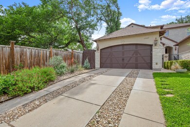 View of front of property with driveway, stone si