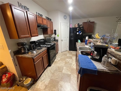Kitchen featuring sink, light tile patterned floor
