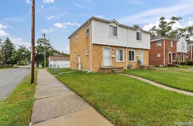 Colonial house with brick siding and a detached garage