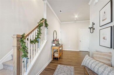 This wide foyer leads to the powder room, great ro