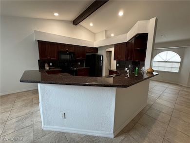 Kitchen featuring tasteful backsplash, a peninsula