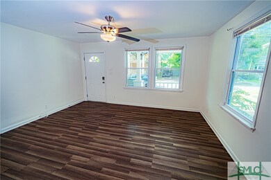 The living room, along with the rest of the interior of the home, boasts fresh paint and new blinds.