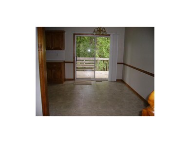 Dining room walks out to deck and lovely treed yar