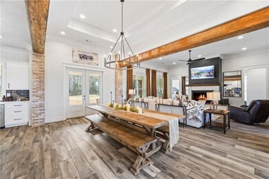 Dining room with crown molding, an inviting chande
