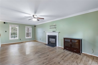 Unfurnished living room featuring ceiling fan, lig