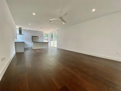 Unfurnished living room with dark wood-style floo