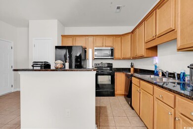Kitchen featuring visible vents, black appliances,