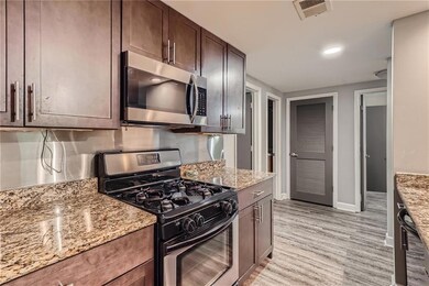 Kitchen with stainless steel appliances, dark brow