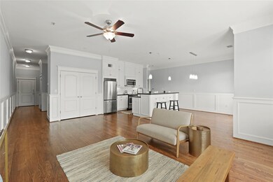 Living area opens to modern kitchen with stainless