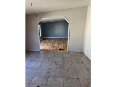 Spare room with lofted ceiling and a textured ceil