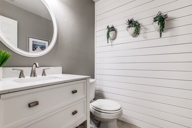  Half bath next to Study has been updated with shiplap, new vanity, mirror & lighting.