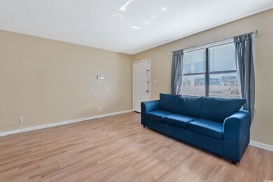 Living room with light hardwood / wood-style floor