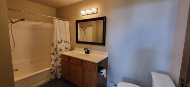 Bathroom with shower / bath combo and vanity