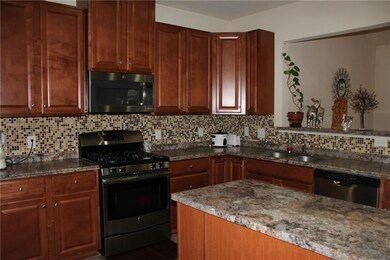 The Kitchen is open to the Family Room. The tiled 