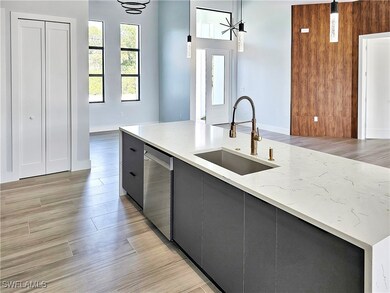 Kitchen featuring dishwasher, pendant lighting, li